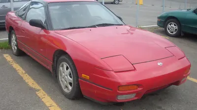 Photo of a Nissan 240SX fastback (S13, post-facelift), red, an example of the Nissan 240SX (S13, 1989-1994)
